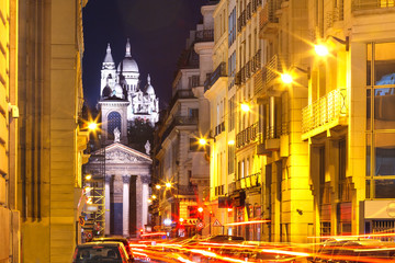 Night view of Sacre-Coeur Basilica or Basilica of the Sacred Heart of Jesus and Notre-Dame de Lorette church, seen from Rue Laffitte, Paris, France