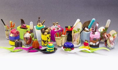 Mini desserts and meat canapes vegetable snacks in plastic cups canapes