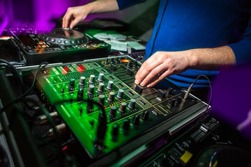 DJ's hands at the music mixer at a party - playing some fine son