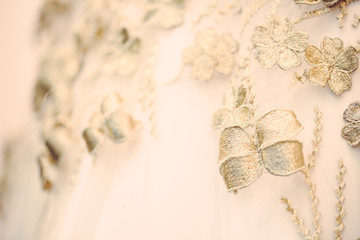 Texture of cloth with details of golden flowers and leaves, luxury