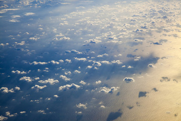 different clouds below, view from a plane