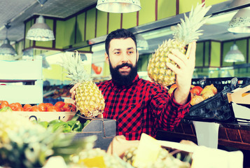 Assistant demonstrating pineapples