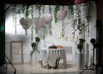 Decoration made of lamps, candles and candlesticks in light tone