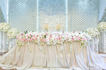 Wedding decoration of table and chairs of bride and groom with flowers