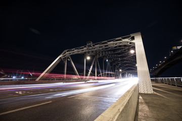 Fototapeta na wymiar Long exposure image of steel bridge with cars movement.