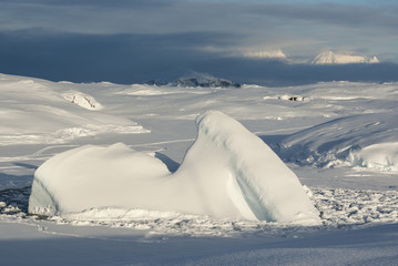 small iceberg frozen into the Straits on the background of the o