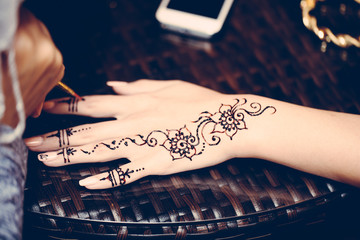 detail of henna being applied to hand