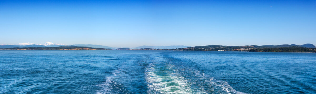View of the San Juan Islands and Washington coast from the stern of a Washington State Ferry leaving Anacortes