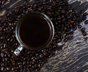 Hot coffee in a cup on wooden background
