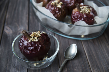 healthy snack in the form of baked red apples with cinnamon and nuts