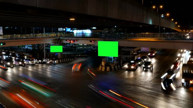 Traffic at night and advertising billboard with green screen, for advertisement, time lapse.