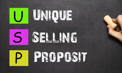 Hand writing USP Unique Selling Proposition with white chalk on