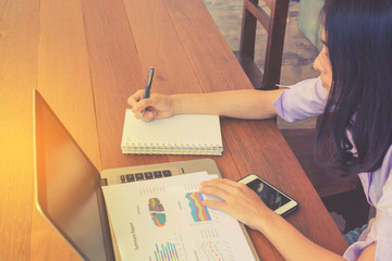 business woman analyzing company annual financial report balance