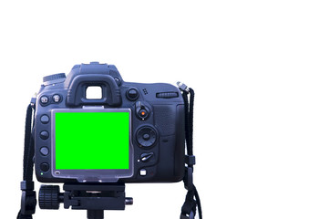 Digital single-lens reflex camera with green screen display stand on tripod isolated on white background