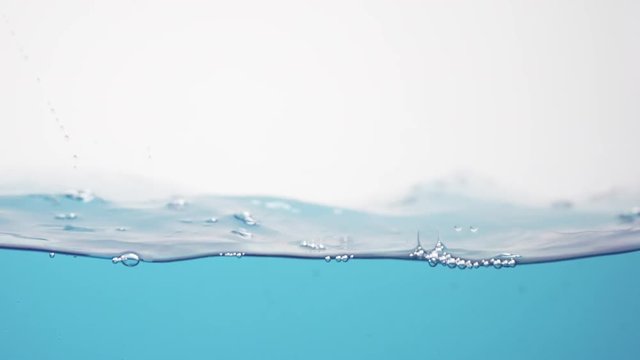 side view of blue toned water waves in slow motion, 180fps prores footage
