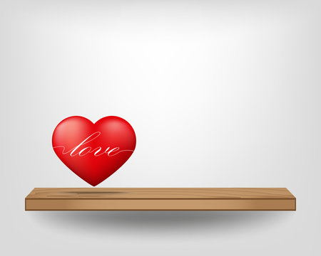 Red heart on wood shelf