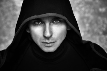 Mysterious Man in Black Hoodie. Sexy Hero Guy. Pastor or Wizard in Robe. Assassin or Witcher with Strong Face Expression in Cloak. Dark Magician Black and White Photo. Fantasy Book Cover Concept. - 132337614