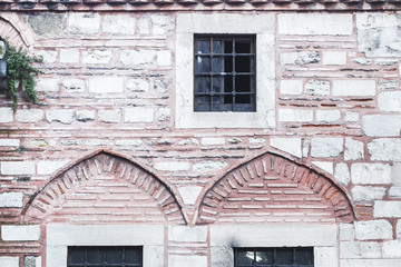 Beautiful stone and bricks facades with different sizes windows