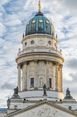 View on German Cathedral at Gendarmenmarkt square on a crips winter day with dramatic cloudy sky, Berlin, Germany