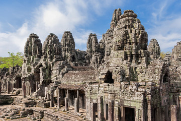 Fototapeta na wymiar Towers with faces in Angkor Wat, temple complex in Cambodia and the largest religious monument in the world. UNESCO World Heritage Site.