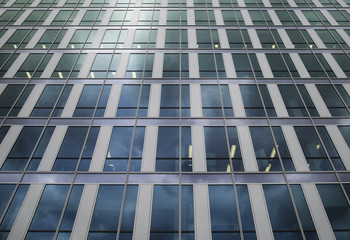 Cold cool blue modern architecture building with reflection windows pattern. Office in the windows.