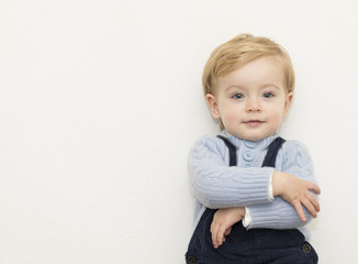 Sweet little kid standing with arms crossed over white backgroun