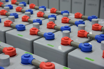 Room with many cables and many batteries.