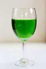Green drinks a glass of wine on the floor.