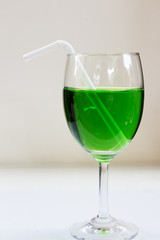Green drinks a glass of wine on the floor.