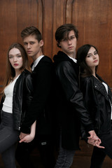 Young elegant trendy friends outdoors, wearing black and white clothing