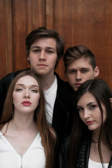Fototapeta premium Young elegant trendy friends outdoors, wearing black and white clothing