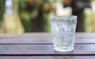 Glass of water on nature background.