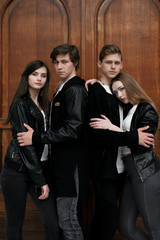 Fototapeta premium Young elegant trendy friends outdoors, wearing black and white clothing