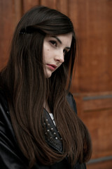 Fototapeta premium Young elegant trendy lady outdoors, wearing black and white clothing