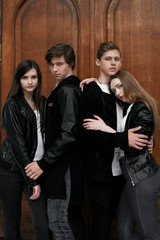 Fototapeta premium Young elegant trendy friends outdoors, wearing black and white clothing