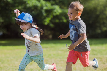 happy children running around outside  playing catch-up concept