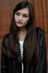Fototapeta premium Young elegant trendy lady outdoors, wearing black and white clothing