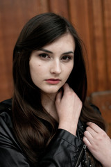 Fototapeta premium Young elegant trendy lady outdoors, wearing black and white clothing