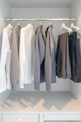 black and white color tone clothes hanging on rail