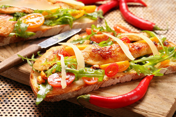 Chicken sandwich on fresh bread with arugula
