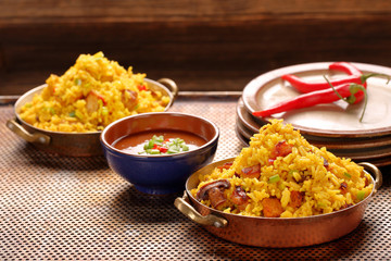 Chicken with basmati rice fried in stainless pan