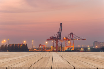 wooden table and industrial port with containers