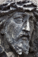 Fototapeta na wymiar Old cemetery marble sculpture of Jesus Christ