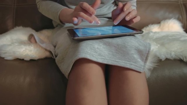 Anonymous woman using touchscreen tablet
