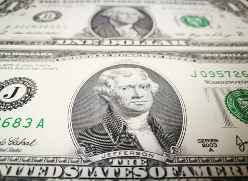 Close up of US dollar bank note with image of Jefferson and Washington. US money background.
