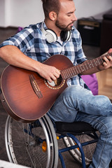 Focused musician playing guitar