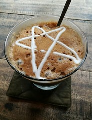 Close up of a coffee cup with star shape of milk cream on surface