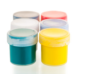 on a white background gouache paint cans close-up