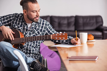 Talented handicapped guy writing song lyrics