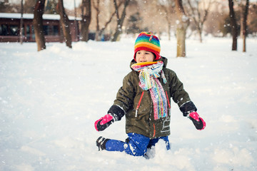 A child is playing in the snow